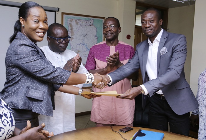 Mr Marcus Deo Dake (right), Head of Fuels Marketing, presenting fuel coupons to Ms Gloria K. Haidzi (left), Executive Secretary, GIBA when GOIL made a donation to the media coalition against galamsey at the GCGL Head Office. Looking on is Ing. Kenneth Ashibey (2nd right), MD, GCGL and Mr Affail Monney, President of GJA. Picture: EMMANUEL ASAMOAH ADDAI